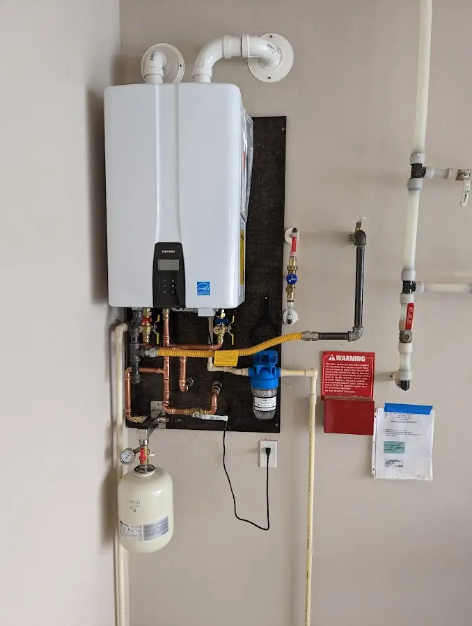 Professional plumber installing copper piping in a Fowler home